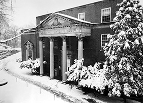 The entrance to the original college library covered in snow